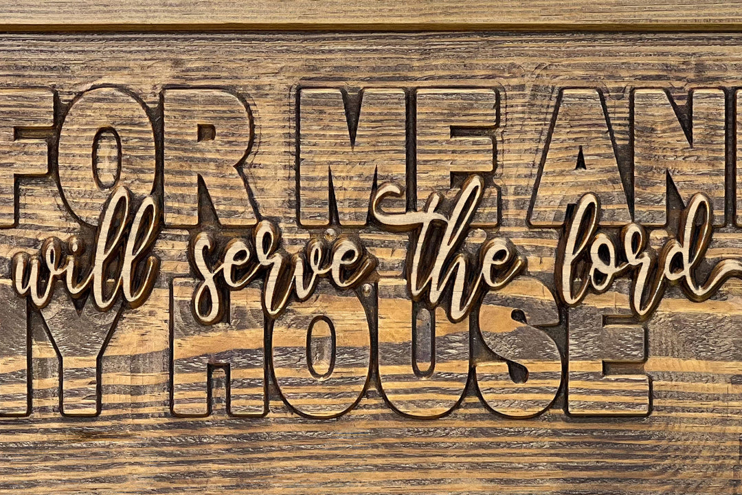 Close-up of the raised 'we will serve the lord' script, sanded to natural wood against the stained field