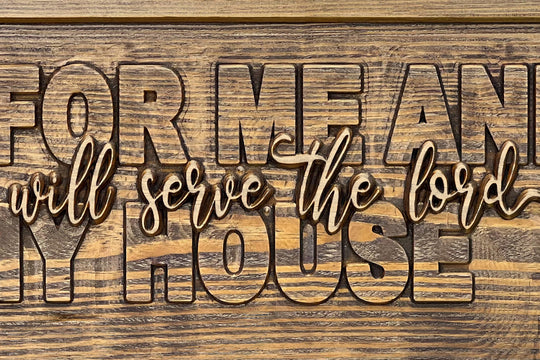 Close-up of the raised 'we will serve the lord' script, sanded to natural wood against the stained field